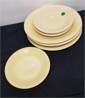 Group of yellow Fiesta plates small and large