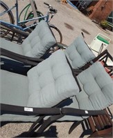 4 black metal chairs with blue cushions