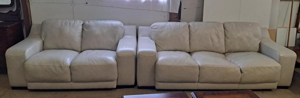 White leather-like couch and matching love seat