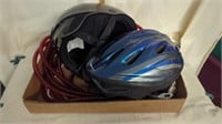 Two bicycle helmets and red rope lights