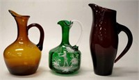 Three antique hand blown glass jugs
