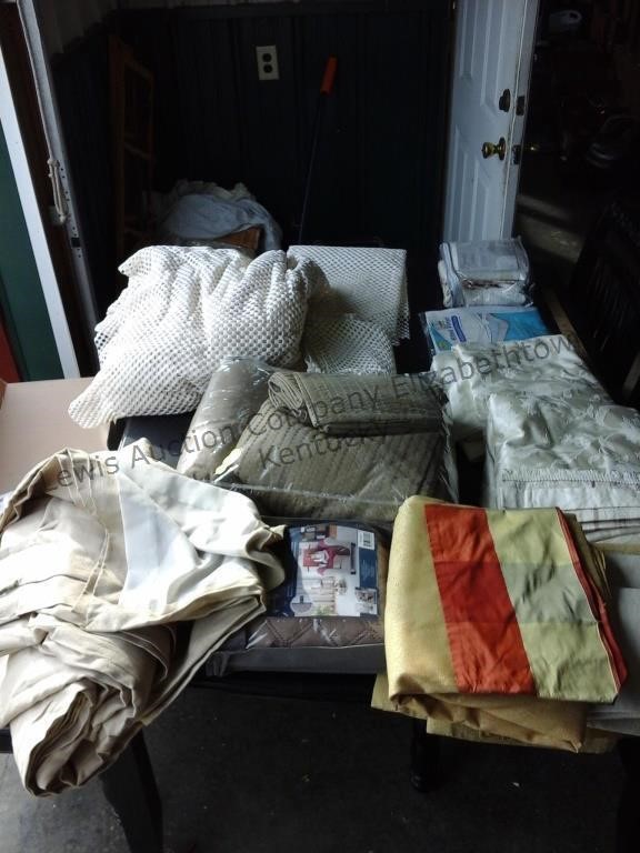 All fabric on table. Large lot of bedding,