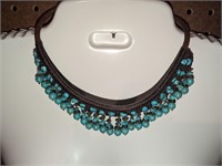Woven choker with turquoise beads.