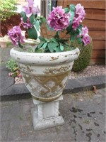 plastic planter with cement base .