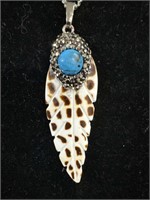 Unique feather with a turquoise cabochon,