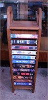 12 VHS movies in oak storage rack