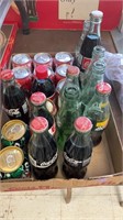 Variety of coca-cola bottles and cans