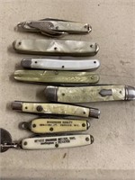 Eight pearl handled pocket knives the two small