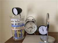 Two alarm clocks, bass, desk lamp, mayor