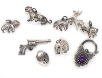 A group of silver charms and clasps