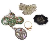 A group of three brooches, a ring and a pendant