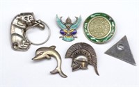 A group of silver brooches and a dolphin pendant