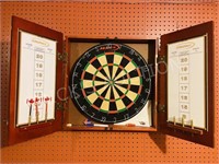 dart board in cabinet w/ darts