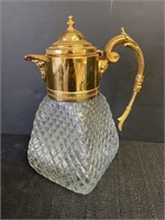 Heavy glass decanter with gold colored metal