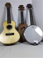 Three ukuleles one is banjo style
