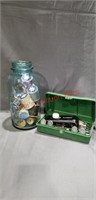 Sewing vintage items w/ thread in a Ball jar.