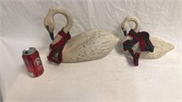 2 carved wooden swans