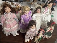 7 porcelain dolls with stands