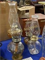 FOUR VINTAGE CLEAR GLASS OIL LAMPS WITH CHIMNEYS