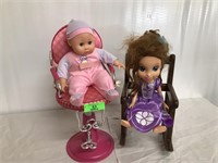 Two dolls in chairs