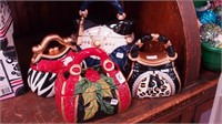 Four colorful cookie jars in the form of purses,