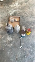 Glass jugs, oil cans, wrench