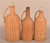 Three Antique Wicker Covered Glass Bottles.