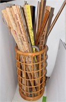 backet of yard sticks and canes