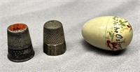 2 silver thimbles and an antique celluloid holder