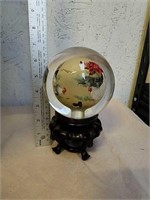Decorative heavy glass paperweight on wood stand