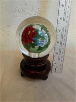 Heavy glass paperweight on wood stand