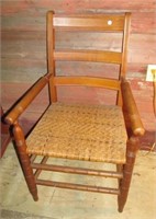 Arm chair with woven seat. Measures 35" tall.