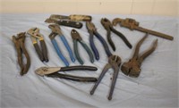 Assortment of pliers, putty knives, pipe wrench,