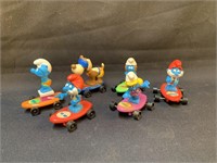Group of Vintage Miniature Smurfs on Skateboard