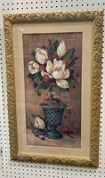 Gold framed print of an urn with flowers.