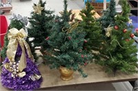 7 small artificial Christmas trees - 2 pre-lit