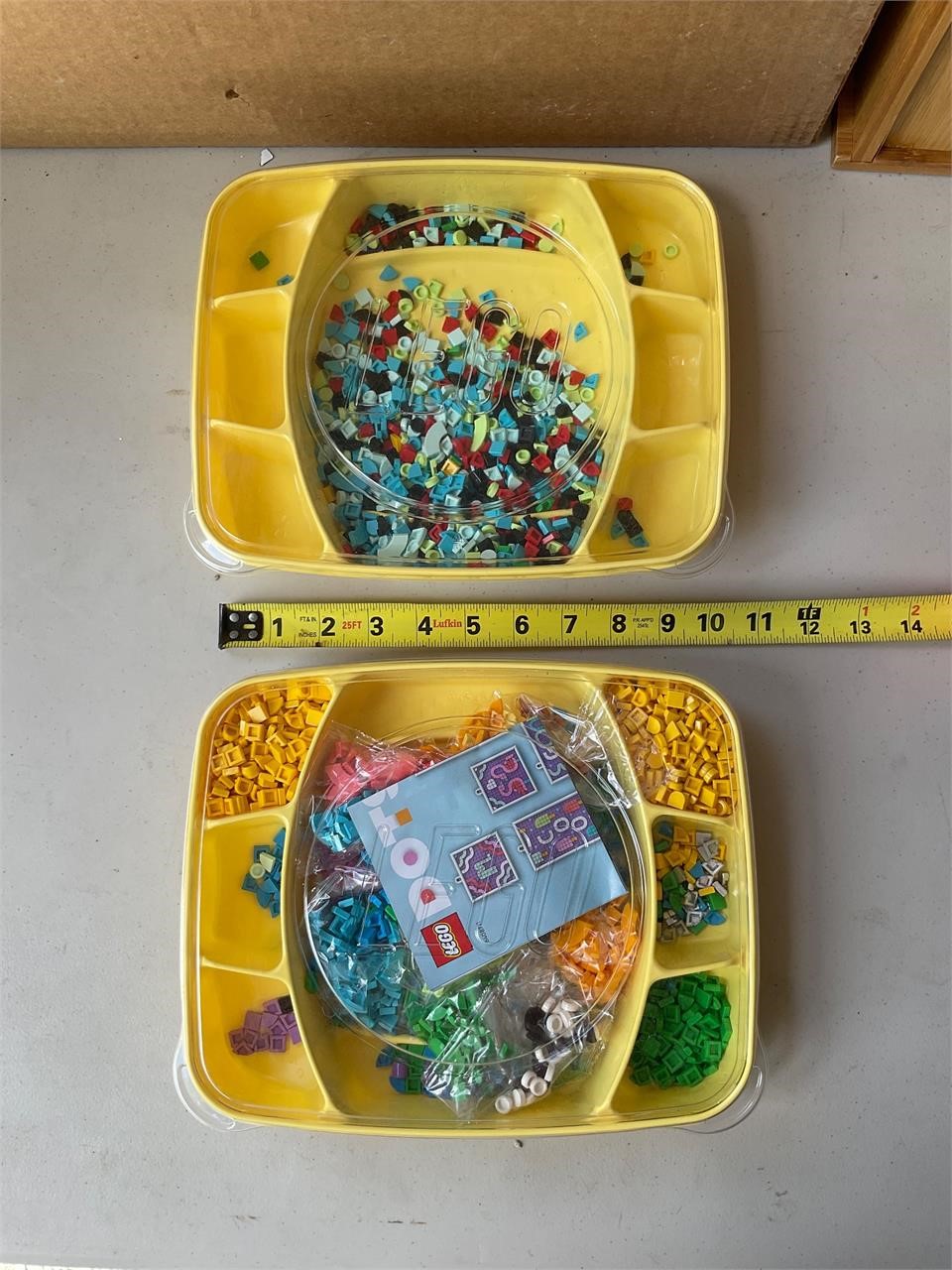 Two containers of Lego dots