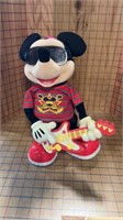 Mickey Mouse playing a guitar