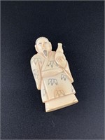 Antique netsuke of a man holding a drink. Approx.