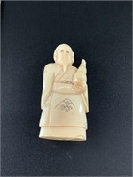 Antique netsuke of a man holding a drink. Approx.