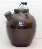 Brown stoneware batter jug with tin lid