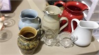 Group of five newer creamers one with the lid and