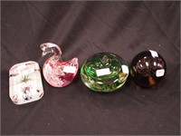 Four colored paperweights: one in the form of a