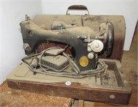 Vintage Singer sewing machine with cover.