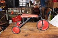 Antique wooden and metal child’s pedal riding toy