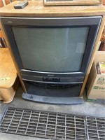 Vintage TV stand with Sony TV and remote
