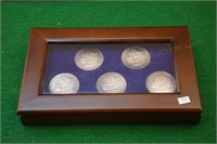 (5) Morgan Silver Dollars in display case
