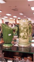 Two pieces of green art pottery decorated with