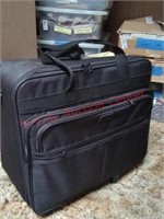 Rolling suitcase with various fabric pieces,