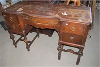Vintage Woodard wood desk with five drawers.
